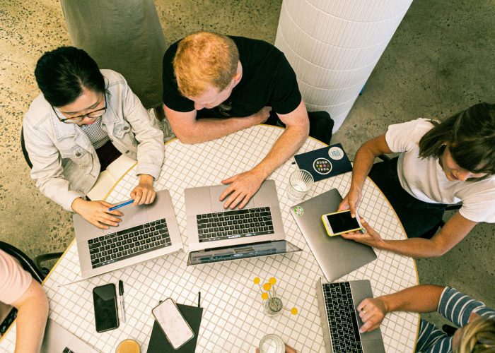 pexels-photo-3194521-3194521 Top view of diverse team collaboratively working in a modern office setting.